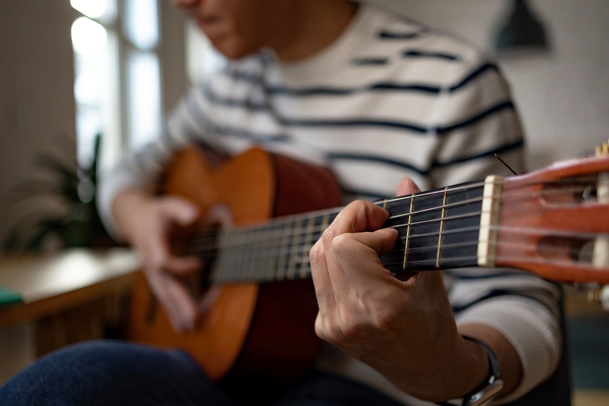 Close-up of hands playing an acoustic guitar