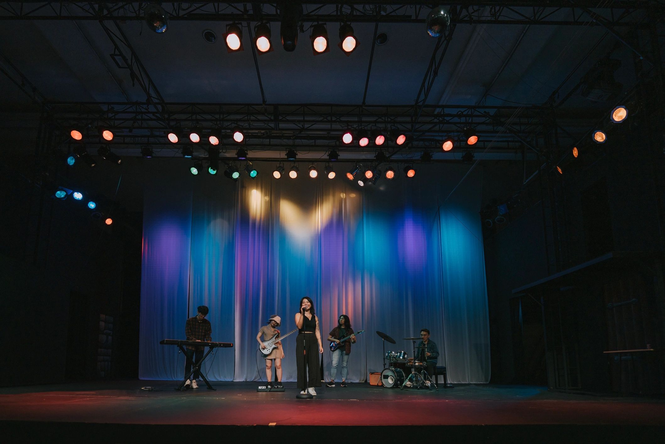 Lead singer and live band performing on stage