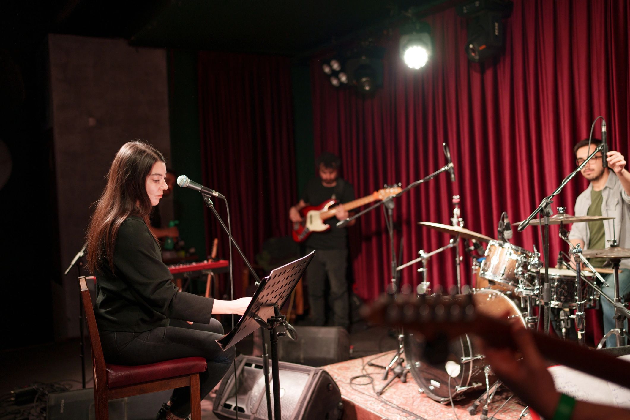 Acoustic band rehearsing together on stage